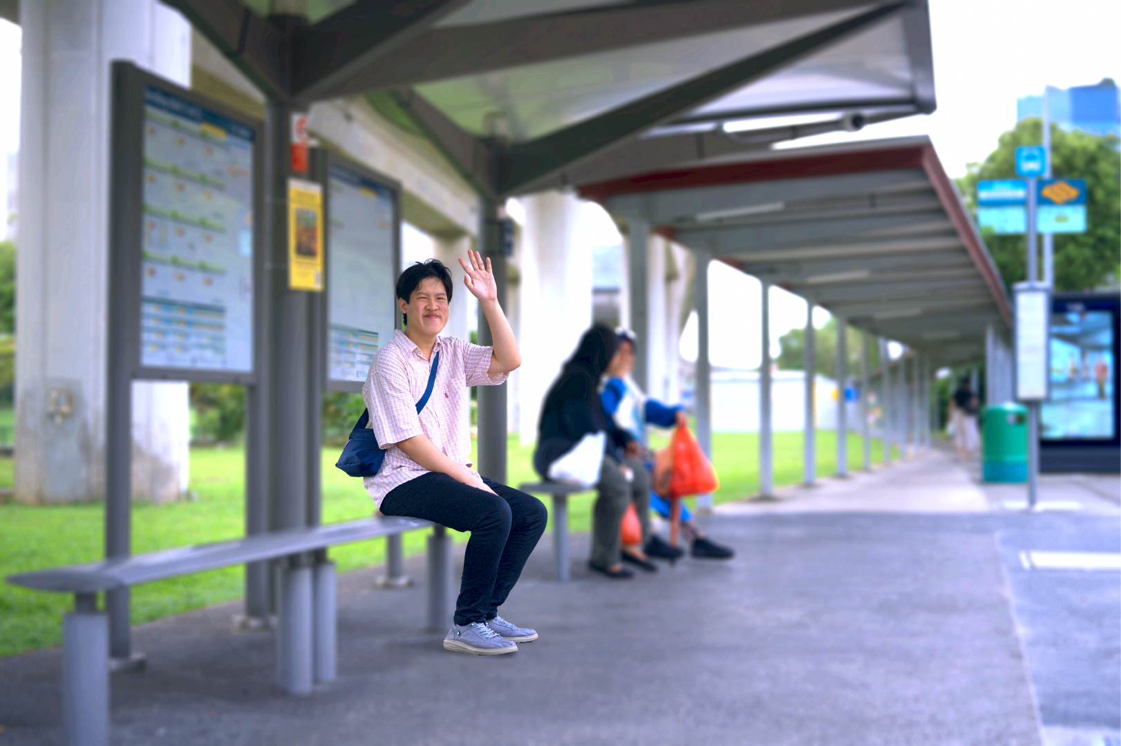 Caring Commuter Champion, Joshua Boo greeting someone at the bus stop